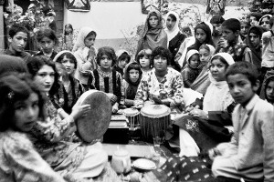 Zainab Herawi with her daughter Anar Gol and one of her sons, relaxing at a social gathering with music, Herat city, May 1977. Photograph by Veronica Doubleday.
